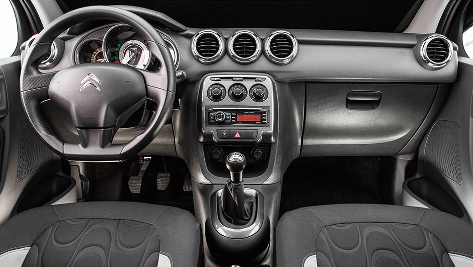 Painel tem tr&ecirc;s sa&iacute;das de ar centrais e porta-luvas generoso | <a href="https://quatrorodas.abril.com.br/carros/comparativos/fiesta-x-208-x-c3-749647.shtml" rel="migration">Leia mais</a>