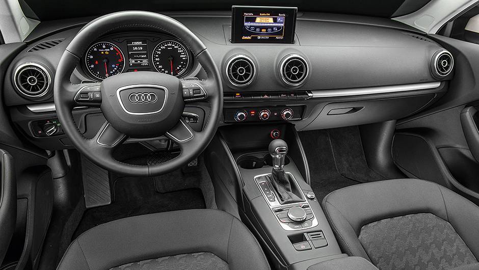 Tela retr&aacute;til e seletor girat&oacute;rio de fun&ccedil;&otilde;es no console | <a href="https://quatrorodas.abril.com.br/carros/comparativos/audi-a3-x-vw-golf-757579.shtml" rel="migration">Leia mais</a>