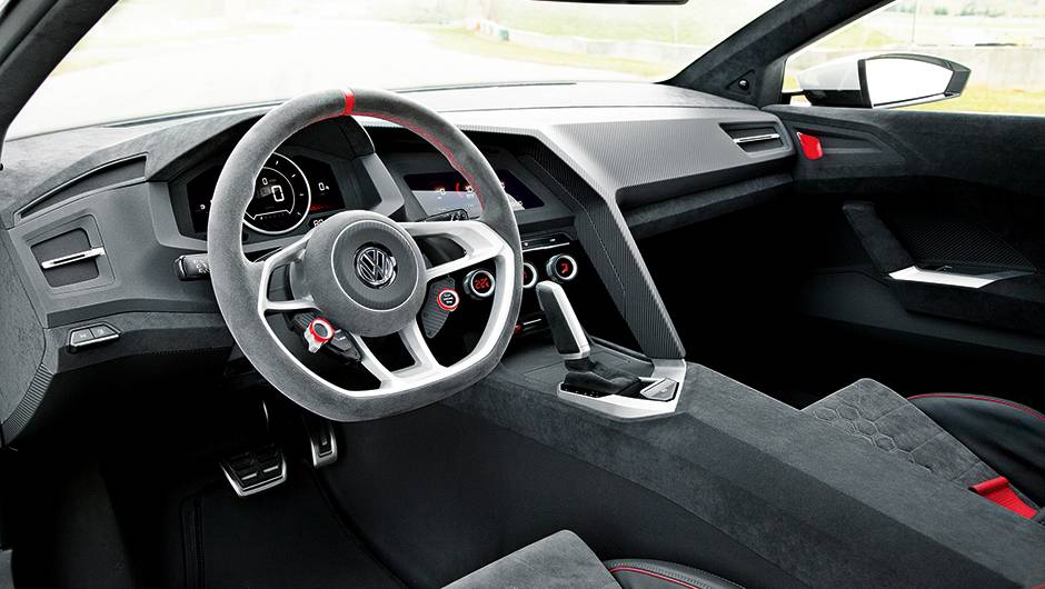 Volante com ponto de refer&ecirc;ncia vermelho no alto e base chata, como num carro de corrida | <a href="https://quatrorodas.abril.com.br/carros/impressoes/volkswagen-design-vision-gti-772455.shtml" rel="migration">Leia mais</a>
