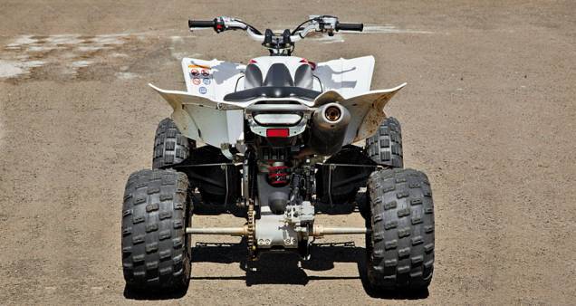 Suspensão traseira ao estilo motociclístico, com balança oscilante e...