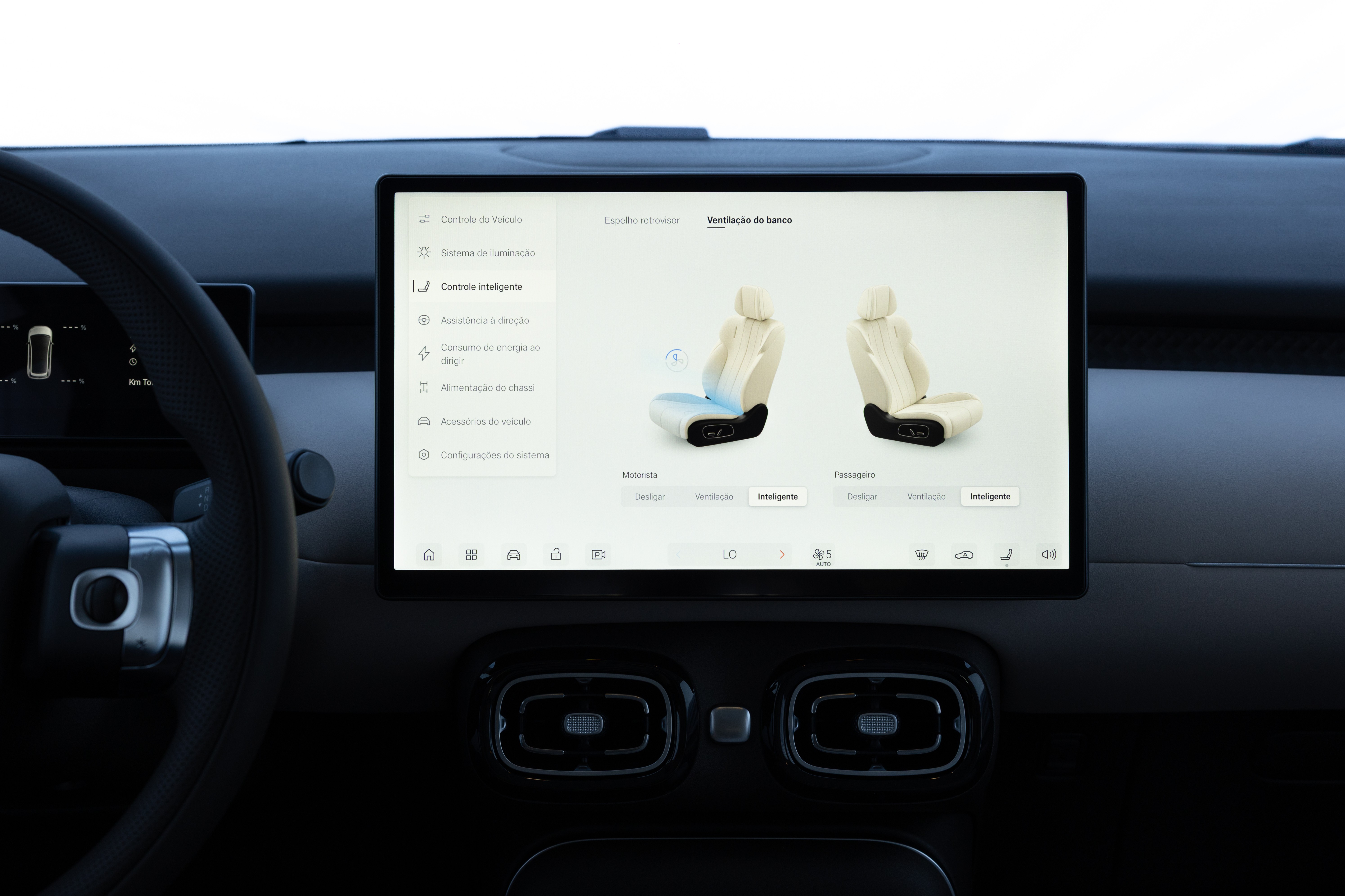 Painel interno de um carro com tela central exibindo opções de ventilação de banco, mostrando dois assentos bege, um com fluxo de ar azul