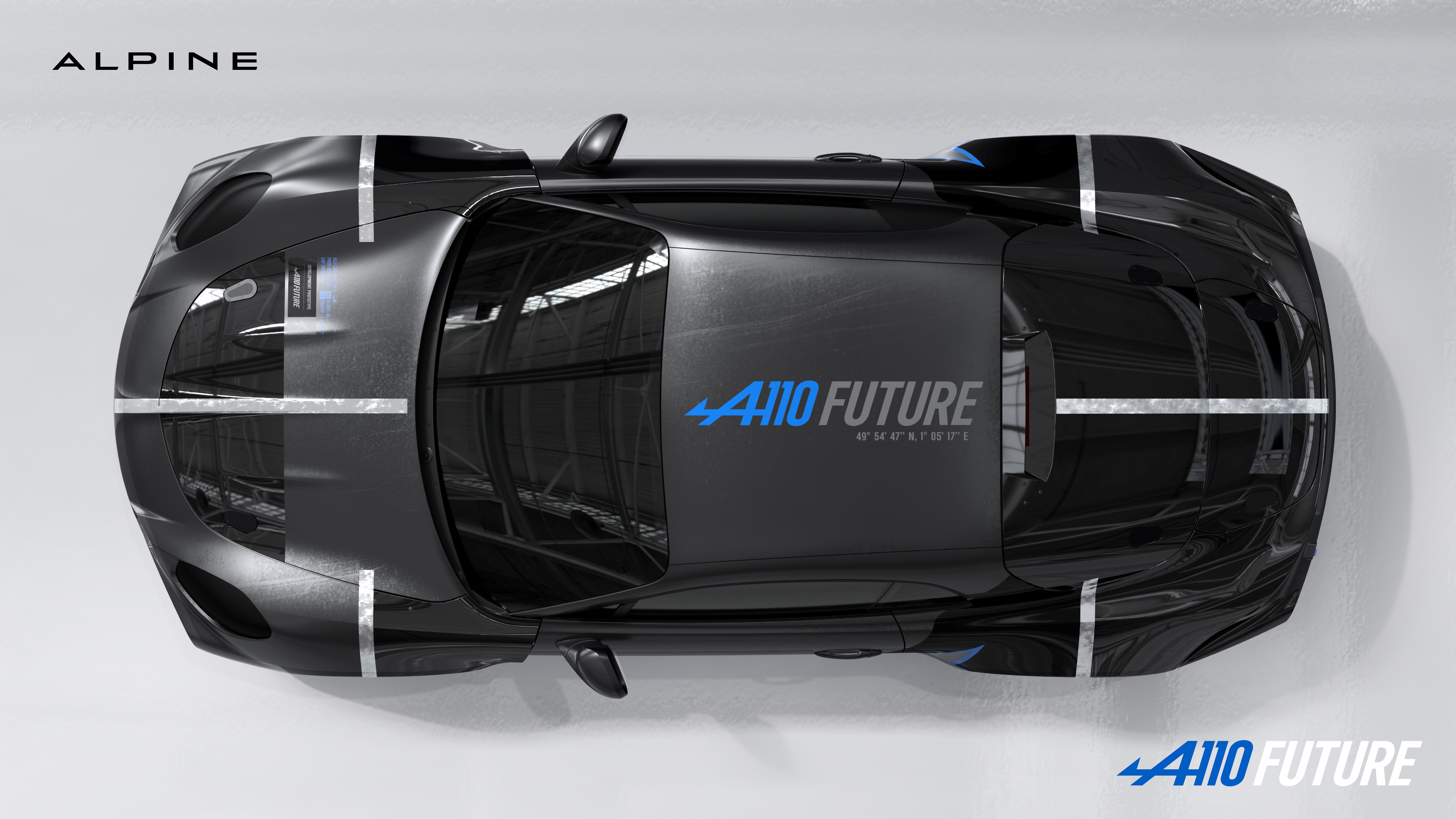 Carro esportivo Alpine A410 Future preto, visto de cima, com faixas prateadas e o logo azul A410 Future na lateral e no canto inferior direito