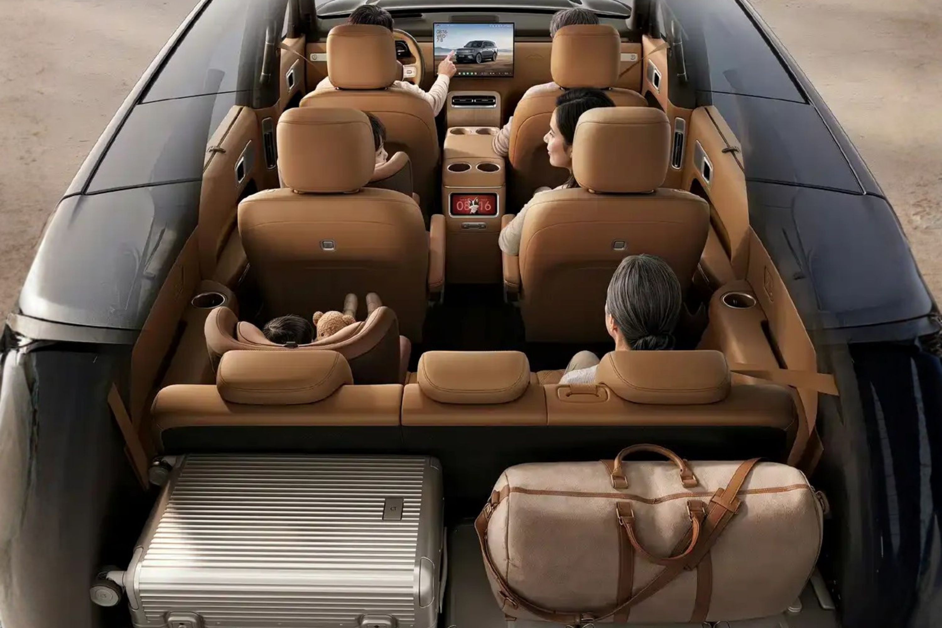 Vista aérea do interior de um carro de luxo com seis pessoas, incluindo um bebê em cadeirinha, e bagagens. Os assentos são de couro marrom claro, e há uma tela no painel exibindo um carro. Uma mala prateada e uma bolsa de viagem bege estão no porta-malas
