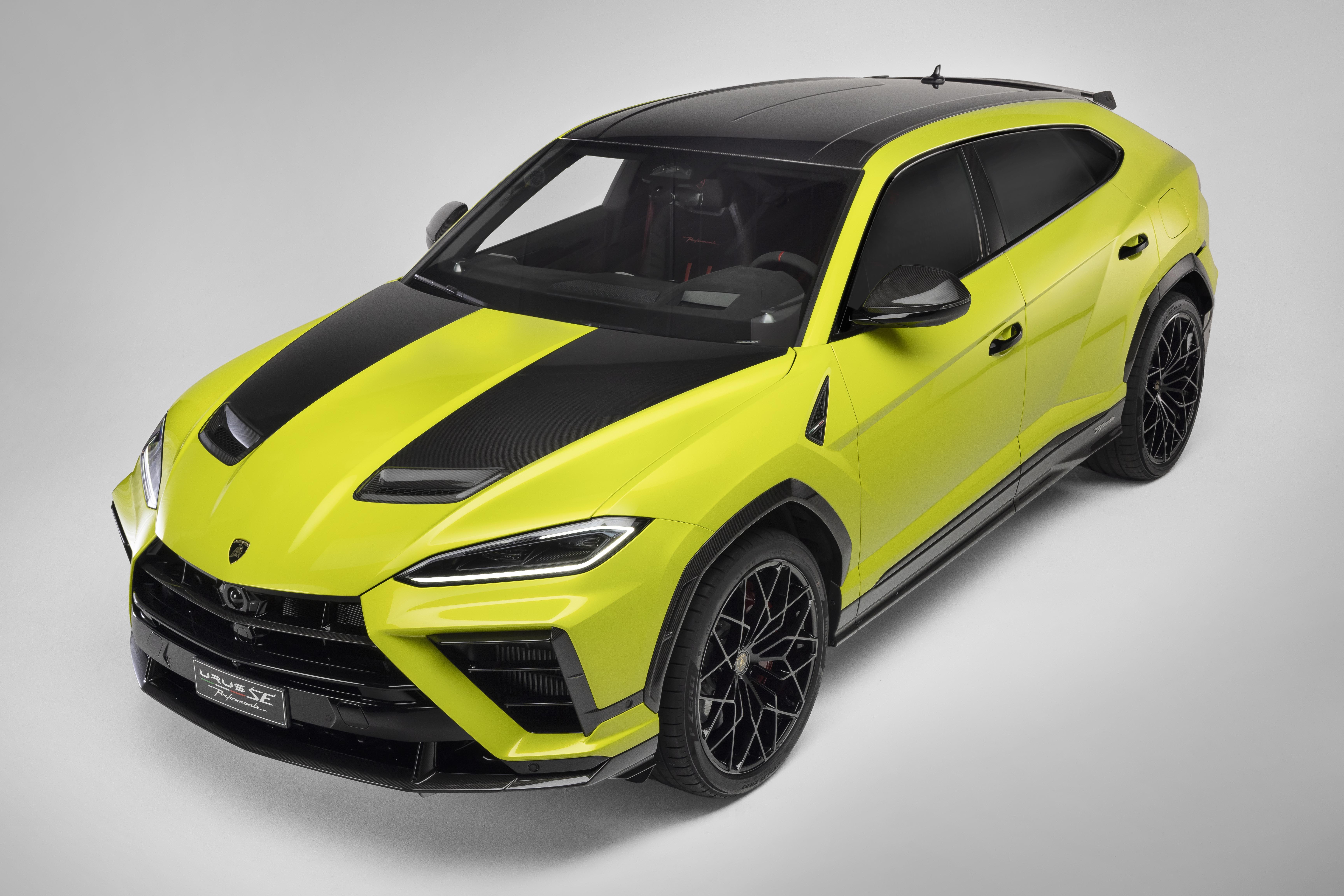 SUV Lamborghini Urus amarelo-limão com faixas pretas no capô e teto, rodas pretas, visto de cima em ângulo, sobre fundo branco