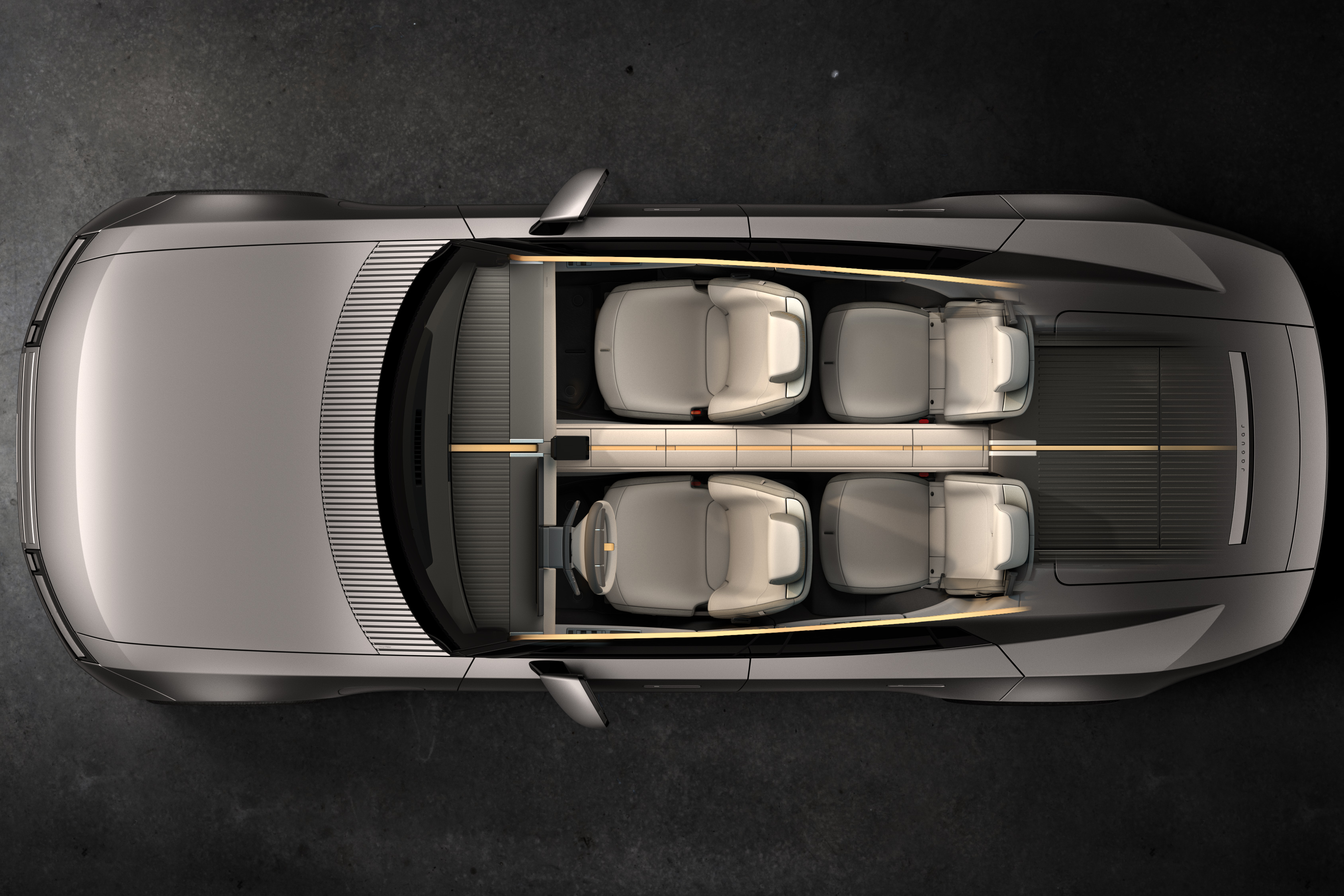 Vista superior de um carro conceito cinza-prateado com interior claro, quatro assentos individuais e design futurista, sobre fundo escuro